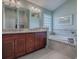 Elegant bathroom with granite countertops and soaking tub at 3590 Ithaca Ter, The Villages, FL 32163