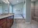 Spa-like bathroom with walk-in shower and soaking tub at 3590 Ithaca Ter, The Villages, FL 32163