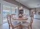 Bright breakfast nook with glass-top table and view of the pool at 3590 Ithaca Ter, The Villages, FL 32163