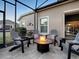 Cozy fire pit area on patio with seating at 3590 Ithaca Ter, The Villages, FL 32163