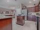 Spacious kitchen featuring granite countertops and stainless steel appliances at 3590 Ithaca Ter, The Villages, FL 32163