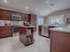 Island kitchen with granite countertops and stainless steel appliances at 3590 Ithaca Ter, The Villages, FL 32163