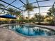 Enjoy this refreshing pool and spa with a screened patio and outdoor seating at 3590 Ithaca Ter, The Villages, FL 32163