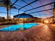 Luminous in-ground pool with a screened enclosure at 3590 Ithaca Ter, The Villages, FL 32163