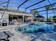 Resort-style pool with a covered patio, outdoor kitchen and seating area at 3590 Ithaca Ter, The Villages, FL 32163