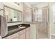 Bathroom featuring a glass enclosed shower with tile surround and neutral cabinets at 37008 Shalimar Dr, Fruitland Park, FL 34731