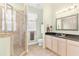 Bathroom featuring a glass enclosed shower with tile surround and neutral cabinets at 37008 Shalimar Dr, Fruitland Park, FL 34731