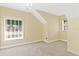 Upstairs bedroom with carpet, large windows and a ceiling fan at 37008 Shalimar Dr, Fruitland Park, FL 34731