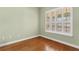 Cozy bedroom featuring hardwood floors, a window and light-colored walls at 37008 Shalimar Dr, Fruitland Park, FL 34731