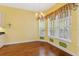 Bright breakfast nook with hardwood floors, chandelier, and large windows at 37008 Shalimar Dr, Fruitland Park, FL 34731