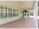 Inviting covered porch featuring a brick floor, offering a shady spot to relax on warm days at 37008 Shalimar Dr, Fruitland Park, FL 34731