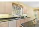 Kitchen featuring granite countertops and a large window at 37008 Shalimar Dr, Fruitland Park, FL 34731