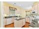 Bright kitchen with white cabinets, granite counters, and stainless-steel appliances at 37008 Shalimar Dr, Fruitland Park, FL 34731