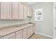 Laundry area with cabinets, counter space, and a sink at 37008 Shalimar Dr, Fruitland Park, FL 34731