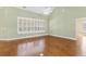 Large living room boasting hardwood floors, bright window and neutral wall color at 37008 Shalimar Dr, Fruitland Park, FL 34731