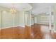 Bright living room featuring hardwood floors, decorative lighting, and an open staircase at 37008 Shalimar Dr, Fruitland Park, FL 34731