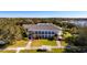 Aerial view of a large home with a sprawling lawn and surrounding trees at 3716 Plantation Blvd, Leesburg, FL 34748