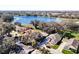 Aerial view of homes surrounding a lake, showcasing the community's landscape at 3716 Plantation Blvd, Leesburg, FL 34748