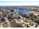 Aerial view of neighborhood with lake and mature trees at 3716 Plantation Blvd, Leesburg, FL 34748