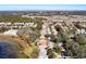 Aerial view of neighborhood with lake and mature trees at 3716 Plantation Blvd, Leesburg, FL 34748