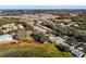 Aerial view of neighborhood with lake and mature trees at 3716 Plantation Blvd, Leesburg, FL 34748