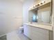 Bathroom with vanity, toilet and a large mirror at 3716 Plantation Blvd, Leesburg, FL 34748