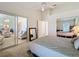 Bright bedroom with mirrored closet and access to other rooms at 3716 Plantation Blvd, Leesburg, FL 34748