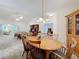 Bright dining room with wood table and chairs, view into living room at 3716 Plantation Blvd, Leesburg, FL 34748