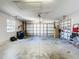 Attached garage with shelving and ample space for storage and vehicles at 3716 Plantation Blvd, Leesburg, FL 34748