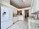 Kitchen features white appliances and granite countertops at 3716 Plantation Blvd, Leesburg, FL 34748