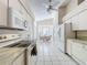 Galley kitchen with white cabinets, granite counters, and appliances at 3716 Plantation Blvd, Leesburg, FL 34748