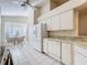 Galley kitchen with white cabinets and granite countertops at 3716 Plantation Blvd, Leesburg, FL 34748