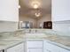 Kitchen features a corner sink and granite countertops at 3716 Plantation Blvd, Leesburg, FL 34748