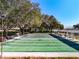 Well-maintained shuffleboard courts under shady oak trees at 3716 Plantation Blvd, Leesburg, FL 34748