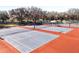 Well-maintained tennis courts with covered seating areas at 3716 Plantation Blvd, Leesburg, FL 34748