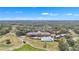 Panoramic aerial view of the community clubhouse, pool, and golf course nestled amidst lush landscapes at 39335 Harbor Hills Blvd, Lady Lake, FL 32159