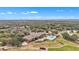 Aerial view of community clubhouse and pool surrounded by greenery and golf course, offering serene recreation at 39335 Harbor Hills Blvd, Lady Lake, FL 32159