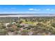 Scenic aerial shot showcasing community clubhouse, pool, and golf course set against serene lakeside backdrop at 39335 Harbor Hills Blvd, Lady Lake, FL 32159