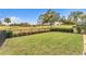 Well-maintained backyard with lush green lawn and garden, enclosed by black aluminum fence, with landscaping at 39335 Harbor Hills Blvd, Lady Lake, FL 32159