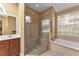 Bathroom with a large shower, soaking tub, and tile flooring at 39335 Harbor Hills Blvd, Lady Lake, FL 32159