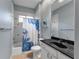 Well-lit bathroom featuring a shower-tub combo, neutral tile, and marble-topped vanity at 39335 Harbor Hills Blvd, Lady Lake, FL 32159