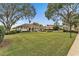 House exterior with a manicured lawn and mature trees at 39335 Harbor Hills Blvd, Lady Lake, FL 32159