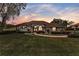 Charming single-story home with manicured lawn, elegant arched entry, and lush, mature landscaping at 39335 Harbor Hills Blvd, Lady Lake, FL 32159