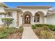 Elegant house entrance with double doors and landscaping at 39335 Harbor Hills Blvd, Lady Lake, FL 32159