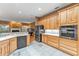 Bright kitchen featuring light wood cabinets, stainless steel appliances and adjacent living space at 39335 Harbor Hills Blvd, Lady Lake, FL 32159