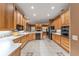 Spacious kitchen featuring light wood cabinetry and modern appliances adjacent to the living room at 39335 Harbor Hills Blvd, Lady Lake, FL 32159