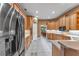 Well-lit kitchen with light cabinetry and stainless steel appliances with views of the dining room at 39335 Harbor Hills Blvd, Lady Lake, FL 32159