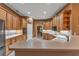 Traditional-style kitchen with wood cabinets, and white countertops adjacent to a breakfast bar at 39335 Harbor Hills Blvd, Lady Lake, FL 32159