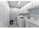 Laundry room with washer, dryer, and extra storage at 39335 Harbor Hills Blvd, Lady Lake, FL 32159