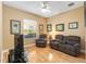 Cozy living room with wood-look floors, neutral walls, comfortable seating, and ample natural light at 39335 Harbor Hills Blvd, Lady Lake, FL 32159